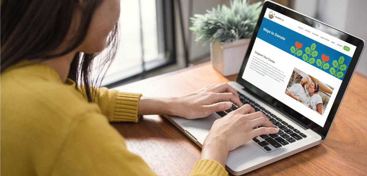 Woman viewing Nourish LA website on laptop